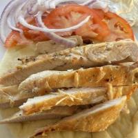 Grilled Chicken On A Pita Bread · Grilled chicken breast on a warm pita with homemade tzatziki sauce, tomatoes, and onions.