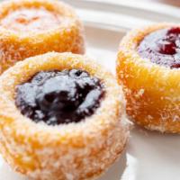 Panquesitos · Dipped in apricot glaze covered with coconut and filled with Apricot, Blueberry or Blackberr...
