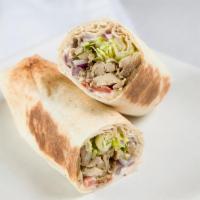 Meat Shawarma · Beef or lamb with onions, tomatoes, pickles, parsley, and tahini sauce.