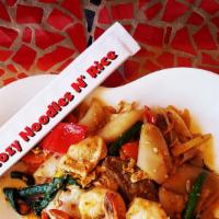 Pad Khee Mao · Stir-fried spicy wide rice noodles with chicken, egg, basil leaves, carrots, green beans and...