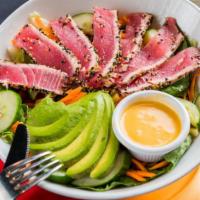 Ahi Tuna Taco Salad · Ahi Tuna served medium rare, with mixed greens, shredded carrots, cucumbers, avocado, Pico d...