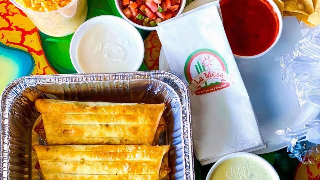 Chimichanga Meal Pack · 4 beef or chicken chimichangas with cheese sauce.
-1 quart rice
-1/2 quart beans

*Includes: lettuce, pico de gallo, sour cream, chips and salsa, silverware, napkins and plates.
