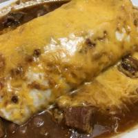 Chorizo Burrito · Spicy sausage and pinto beans rolled in large flour tortilla. (pictured topped with beef chi...