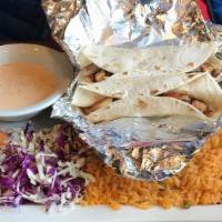 Fish Tacos · Three tacos, your choice of corn or flour tortilla, served with a side of shredded cabbage, ...