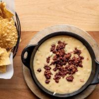 Queso Con Chorizo · Cheese dip spiked with Mexican cerveza, chile serrano, and house made chorizo sausage. Comes...
