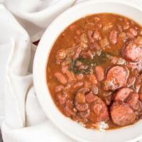 Red Beans And Rice · Creamy slow cooked camellia beans with yellow onion, smoked sausage, and Cajun seasonings. S...