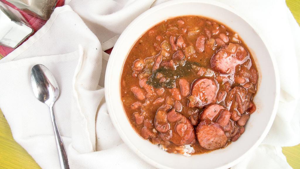 Red Beans And Rice · Creamy slow cooked camellia beans with yellow onion, smoked sausage, and Cajun seasonings. Served over steamed rice with Texas toast.