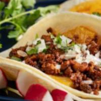Al Pastor Street Tacos · 4 tacos. Marinated pork shoulder topped with cilantro, onions, lime and choice of sauce on c...