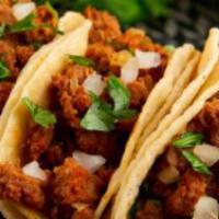 Mexican Chorizo Street Tacos · 4 tacos. Mexican chorizo topped with cilantro, onions, lime and choice of sauce on corn tort...