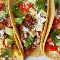 Mexican Chorizo Tacos Rancheros · 4 Mexican Chorizo Tacos, topped with pico de gallo, sour cream, cotija cheese and lettuce on...