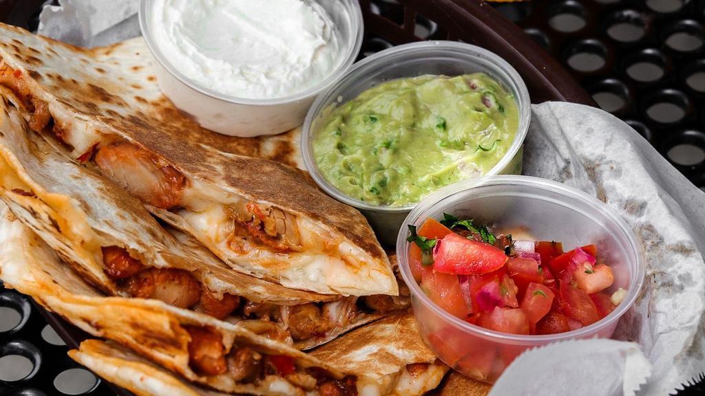 Quesadilla · A grilled flour tortilla stuffed with your choice of protein and cheese. Served with a side of pico de gallo, sour cream, and our house-made salsa.