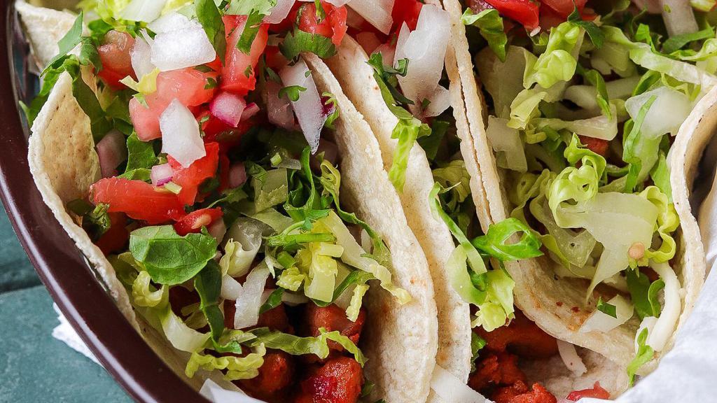 Dos Hermanos Tacos · 3 Soft corn tortillas filled with your choice of meat then topped with lettuce, cheese, pico de gallo, onions and cilantro. Served with your choice of salsa.