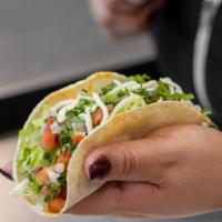 Single Dos Hermanos Taco · 1 soft corn tortilla filled with your choice of meat and topped with lettuce, cheese, pico d...