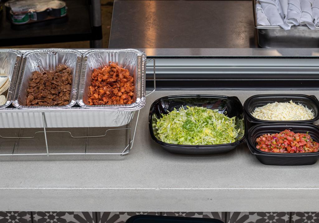 Taco Buffet · 30 Soft Corn Tortillas with your choice of protein, Lettuce, Cheese, Pico de Gallo, Hot, Mild & Guacamole Salsas.        Plates, napkins, and forks are also provided. (Enough to make 30 Tacos, Serves 10-15 people. 1.5 oz meat per taco)

***Please note that our taco buffet can take up to an hour to make***
***Heating elements are not included, but can be added on for an additional cost***