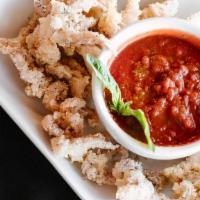 Fried Calamari · Lightly breaded and fried until golden brown. Served with mixture of marinara and pesto.