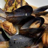 Nero E Verde · Steamed green & black mussels, lemon, onion, garlic in a chardonnay broth, with grilled zucc...