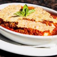 Lasagna · Layered pasta, ricotta, mozzarella, parmesan, red
wine meat sauce, parmesan crisps. Very che...