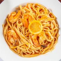 Shrimp Scampi · Garlic butter, parmesan, paprika, and lemon sauce tossed with linguine.