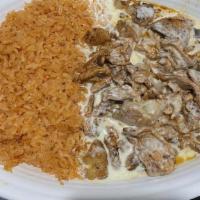 Pollo Al Queso · Grilled chicken, topped with cheese sauce, served with rice and beans.