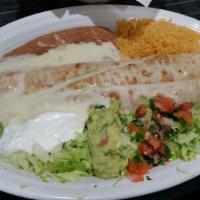 Fajita Chimichanga · Your steak or grilled chicken chimichanga, topped with cheese sauce and served with rice and...