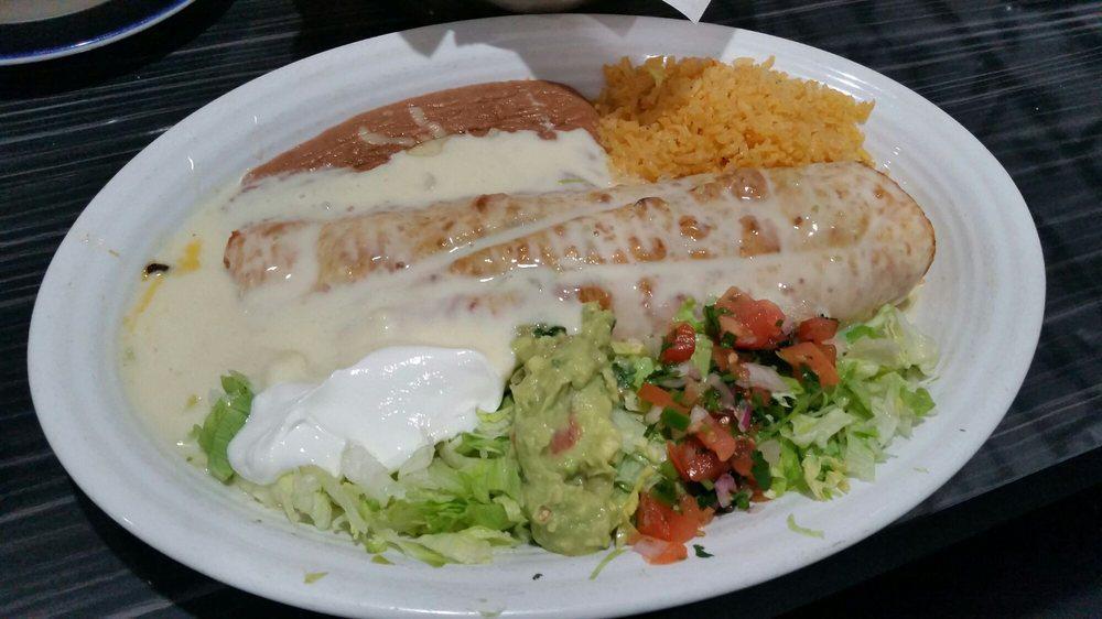 Fajita Chimichanga · Your steak or grilled chicken chimichanga, topped with cheese sauce and served with rice and beans, lettuce, pico de gallo, sour cream and guacamole.