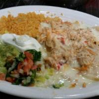 Enchiladas Rancheras · Three cheese enchiladas topped with shredded chicken and red sauce, served with rice, lettuc...
