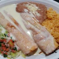 Macho Chimichanga · Your choice of beef or chicken chimichangas, topped with cheese sauce and served with rice, ...