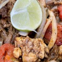 Mixed Fajitas · Steak and chicken grilled with peppers, tomatoes and onions, served with rice, beans, lettuc...