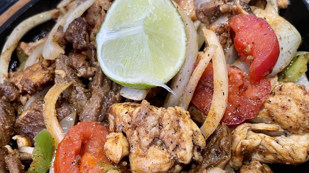Mixed Fajitas · Steak and chicken grilled with peppers, tomatoes and onions, served with rice, beans, lettuce, pico de gallo, sour cream and guacamole.