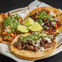 Taco De Chorizo · Tacos are made with larger tortillas, served with cilantro and onion.