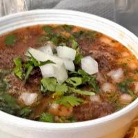 Consomé · Birria hot soup with onions cilantro and onions.