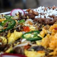 Machaca Con Huevo · Mexican beef dish preapred with eggs grilled jalapeno onions and tomatoes.