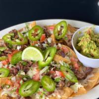 Nachos Con Carne · Spicy. Grilled chopped steak, mozzarella cheese, in a Mexican sauce, with a guacamole.