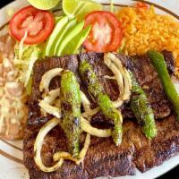 Carne Asada / Grilled Steak · Marinated steak with grill onions, grilled jalapeño peppers & avocados. Sided with rice and ...