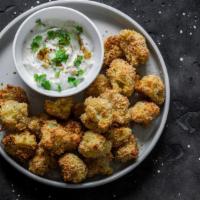 Popcorn Cauliflower Bites · Hand battered in rice flour tempura, these crispy bites are topped with black sesame seeds a...