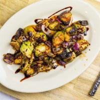 Roasted Brussels Sprouts · Oven roasted Brussels sprouts, red onion, and maple honey glaze.