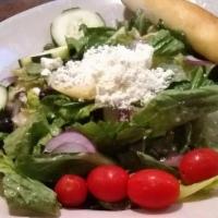 Mediterranean Greek Salad · Romaine lettuce with Kalamata olives, tomatoes, red onions, cucumber, and artichoke in Medit...