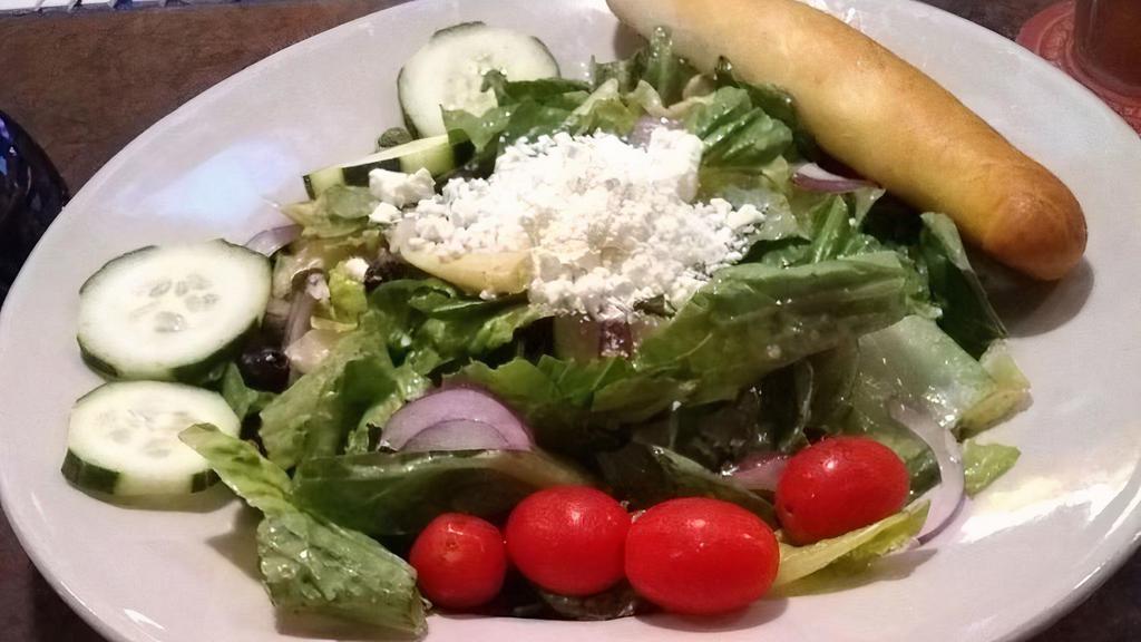 Mediterranean Greek Salad · Romaine lettuce with Kalamata olives, tomatoes, red onions, cucumber, and artichoke in Mediterranean dressing topped with feta cheese. Served with a breadstick. Add grilled chicken for additional charge.