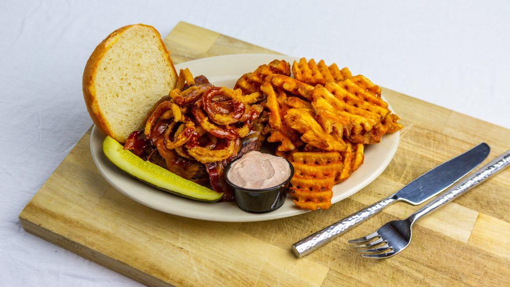 Big Rodeo Burger · Topped with bacon, cheddar, bourbon BBQ sauce, and crispy fried onion on toasted bun.