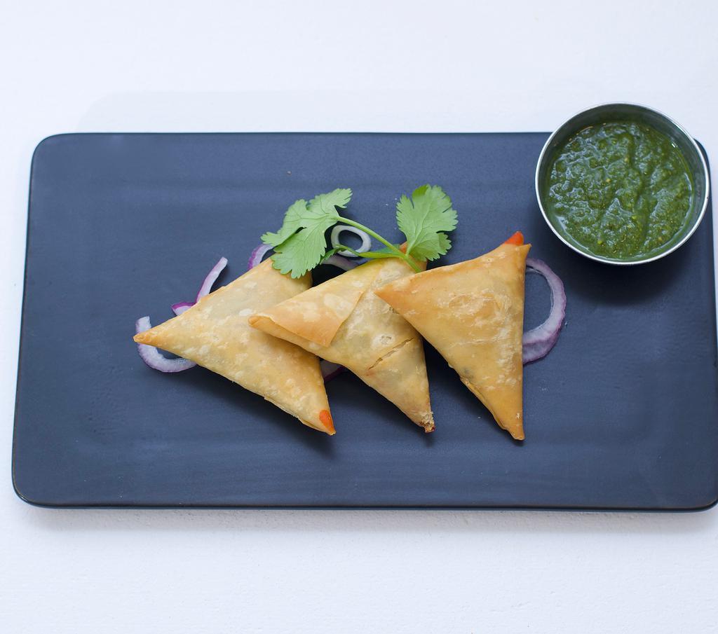 Vegetable Samosa (3) · Crispy fried triangular pastry, stuffed with seasoned mashed potatoes green peas, mint, cilantro and a touch of curry leaves for freshness.