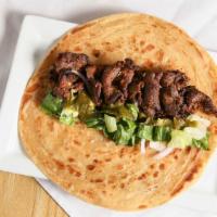 Bihari Kabab Roll · Thin strips of tenderized beef wrapped inside a Paratha with lettuce and caramelized onions....