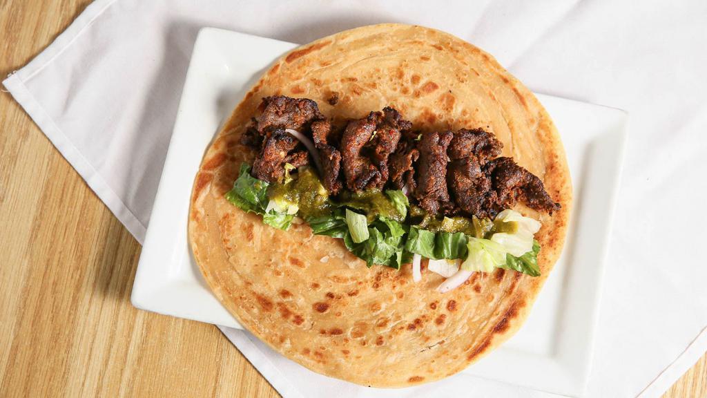 Bihari Kabab Roll · Thin strips of tenderized beef wrapped inside a Paratha with lettuce and caramelized onions. Chatnee served on the side.