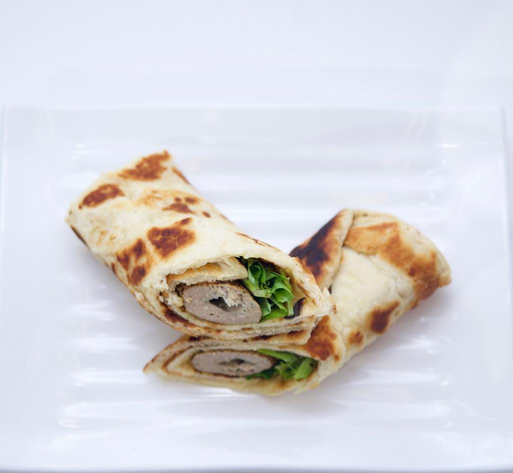 Seekh Kabab Roll · Minced and skewered beef kabab wrapped inside a Paratha with lettuce and caramelized onions. Chatnee served on the side.