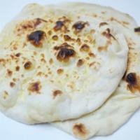 Butter Naan · Freshly baked flatbread, Soft and fluffy from the top crispy from the back, topped with butt...