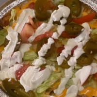 Loaded Fries · Your choice of steak chicken or ground beef topped with nacho cheese lettuce sour cream and ...