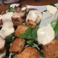 Caesar Salad · Romaine lettuce and homemade croutons tossed with traditional Caesar dressing. Topped with f...