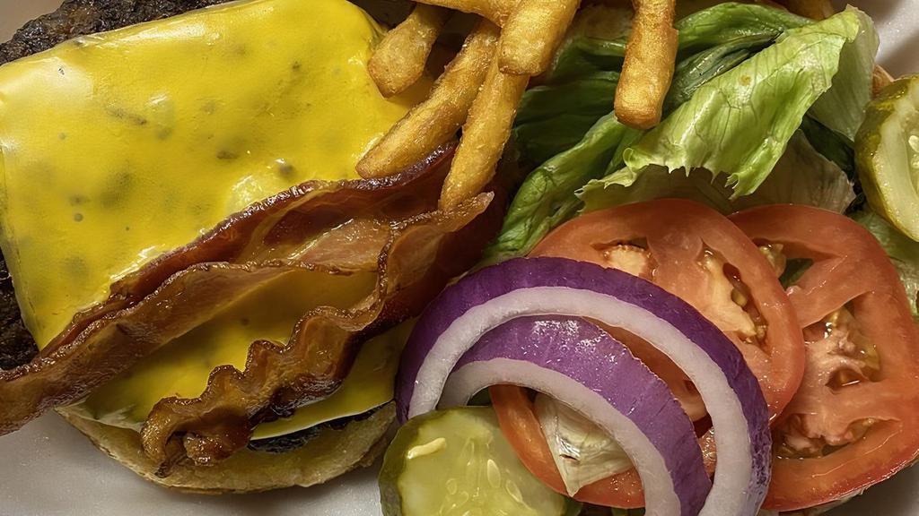 Bacon Cheese Burger · 1/2 lb house blend of ribeye sirloin and chuck , thick-cut applewood smoked bacon, American cheese, lettuce, tomato and onion on a brioche bun.
