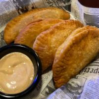 Traditional Latin Empanadas · Four served with your choice of side. The Original 