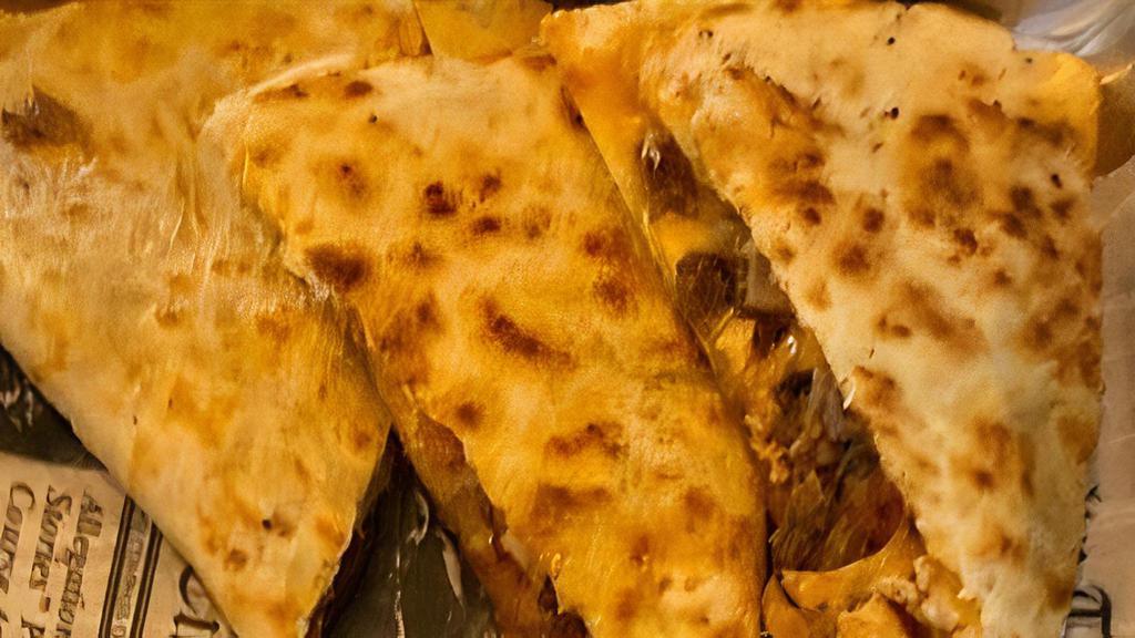 Jumbo Chicken Quesadilla · Flour tortilla oozing with mozzarella, cheddar cheese and grilled onion filled with grilled chicken tossed in your choice of  Munchies Hot or Mild. Served with our Chipotle sauce and  side of either fries or salad.