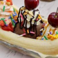 Banana Split · Waffle topped with sliced bananas, fresh strawberries, ice cream, whipped cream, and chocola...